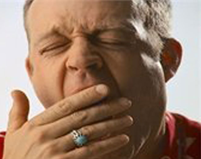 Person covering mouth while yawning