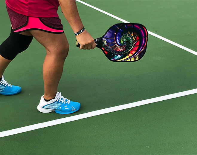 Person playing pickleball on court