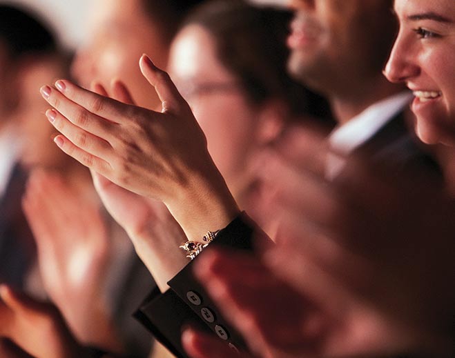 Audience applauding during live event