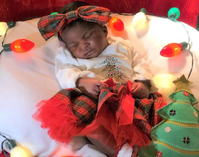Sleeping baby in holiday outfit