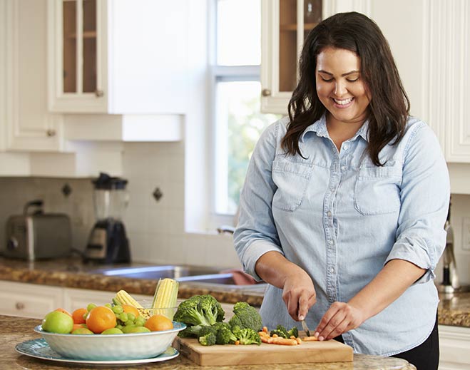 Person chopping vegetables in kitchen