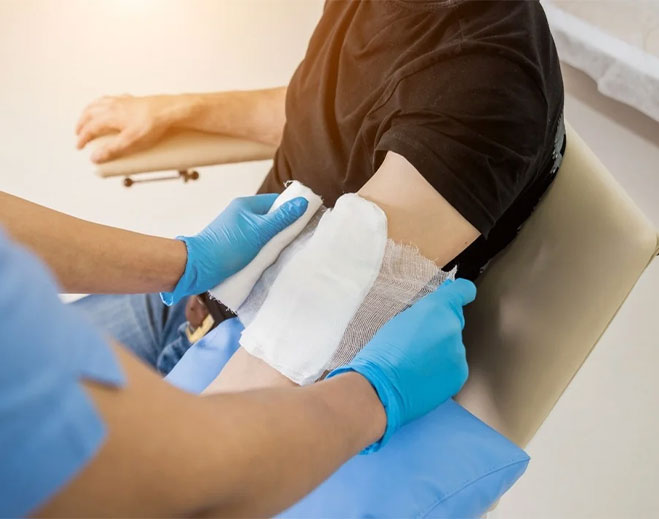 Healthcare worker bandaging patient arm