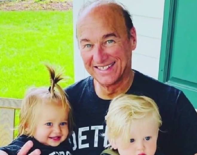 Grandparent holding two young children