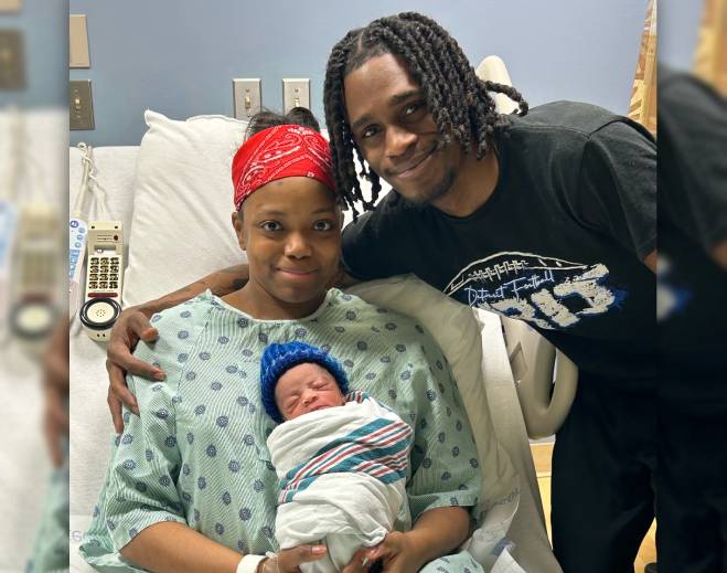 Parents holding newborn in hospital