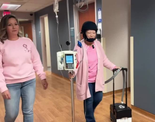 Patient walking in the hospital hallway with IV