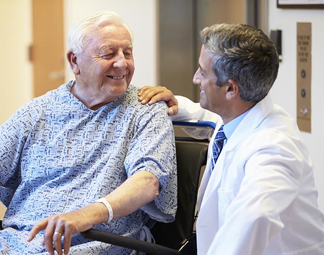 Doctor speaking with patient in hospital