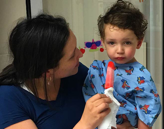 Caregiver holding child with popsicle