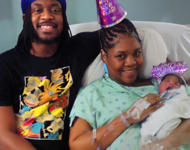 Family celebrating newborn in hospital