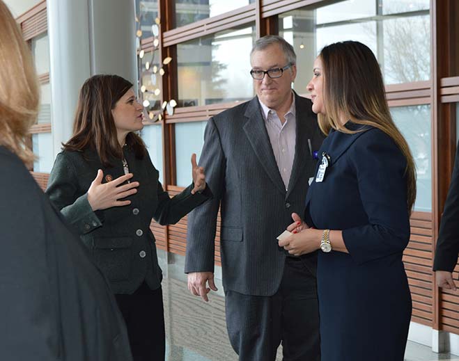 Professionals discussing inside hospital hallway