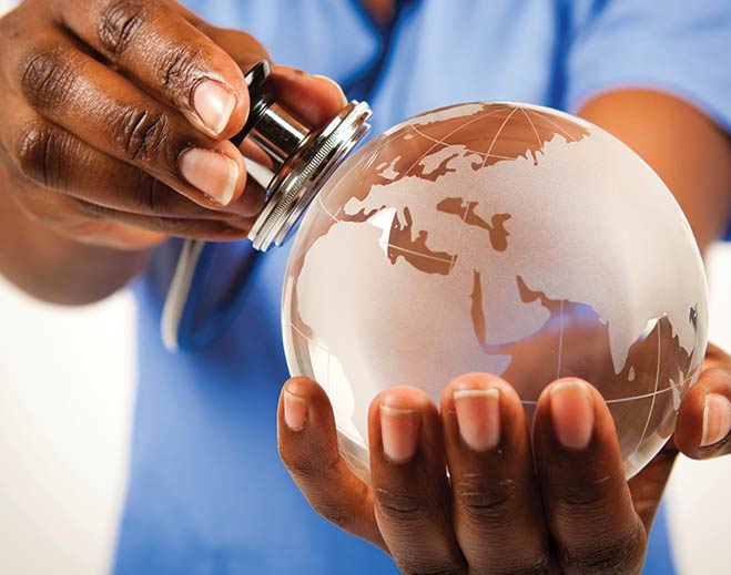 Stethoscope examining globe in hands
