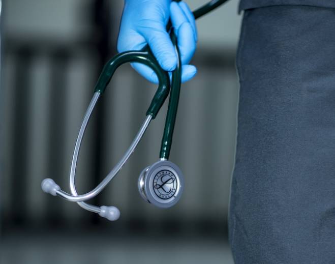 Healthcare worker holding stethoscope