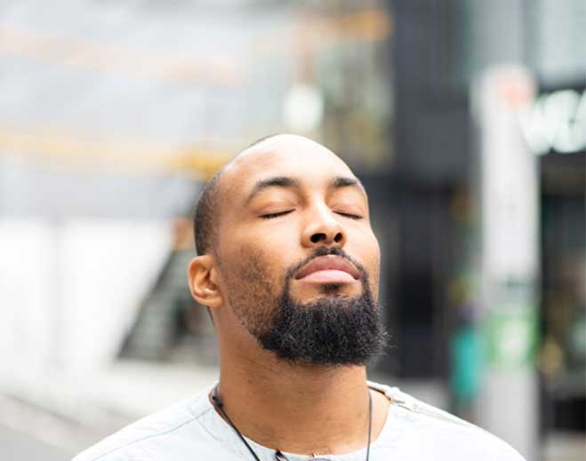 Person practicing mindfulness with eyes closed