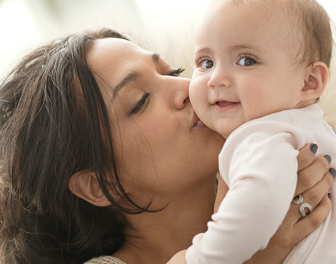 Person holding baby close to face