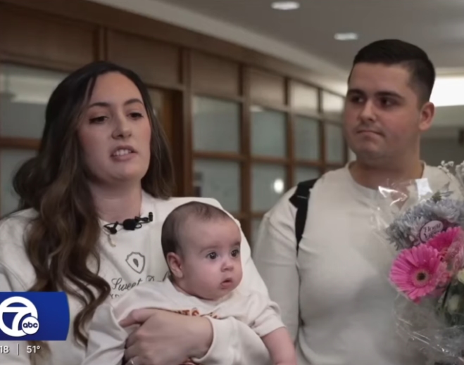 Parents holding baby during interview