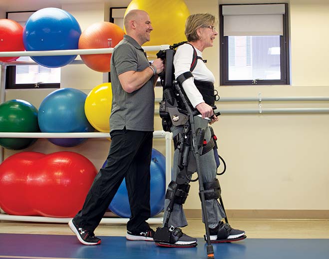 Patient using robotic exoskeleton in therapy