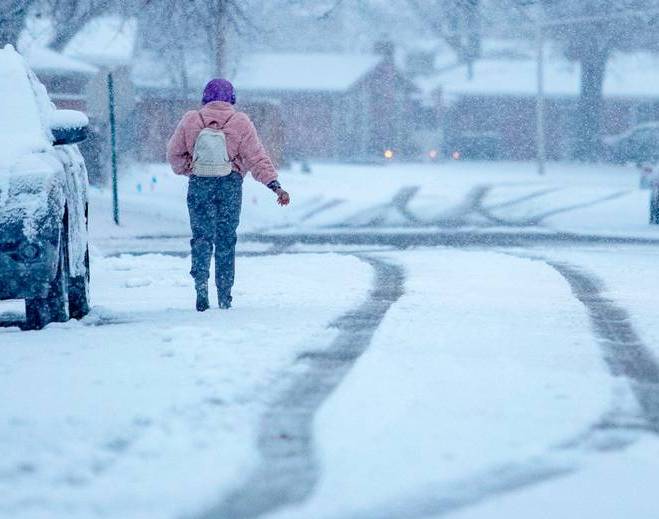 Person walking outdoors during snowstorm