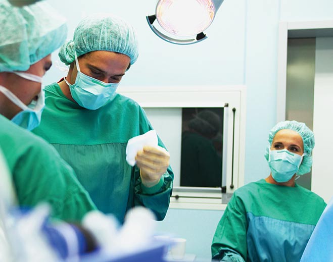Surgeons performing operation in operating room