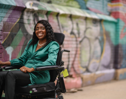 Shanta using wheelchair on urban street