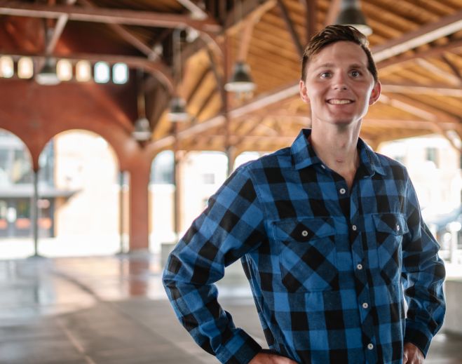 Cody standing in open hall interior