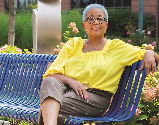 Debra sitting on park bench outdoors