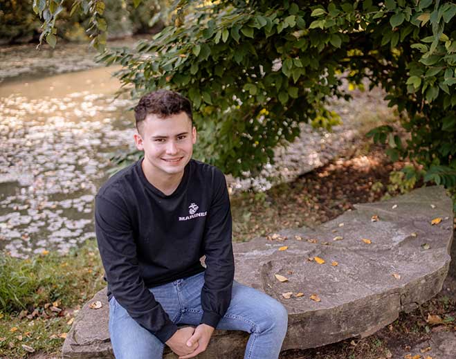 Jacob sitting by pond in park