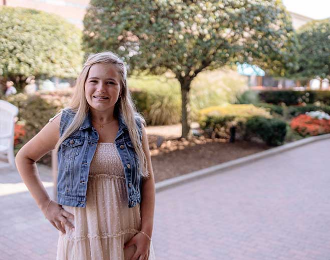 Michaela standing in garden with pathway