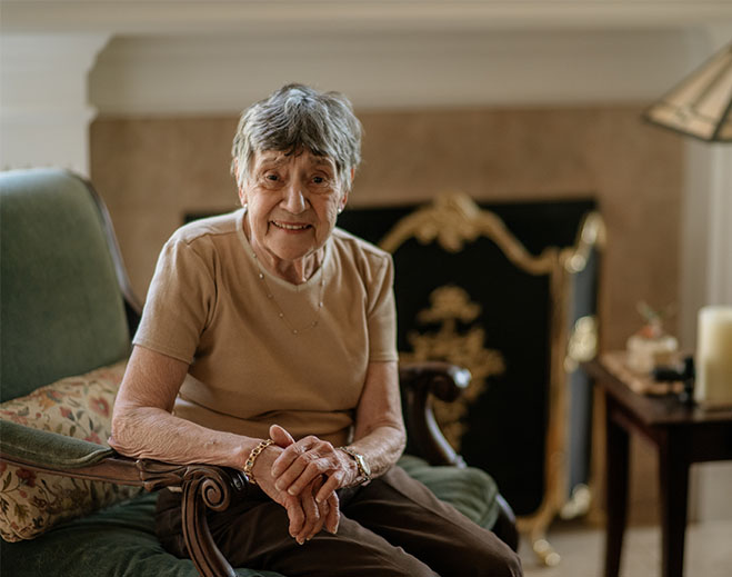 Debra seated in living room chair