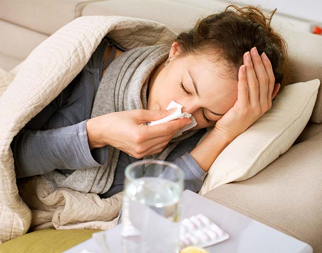 woman in bed with runny nose