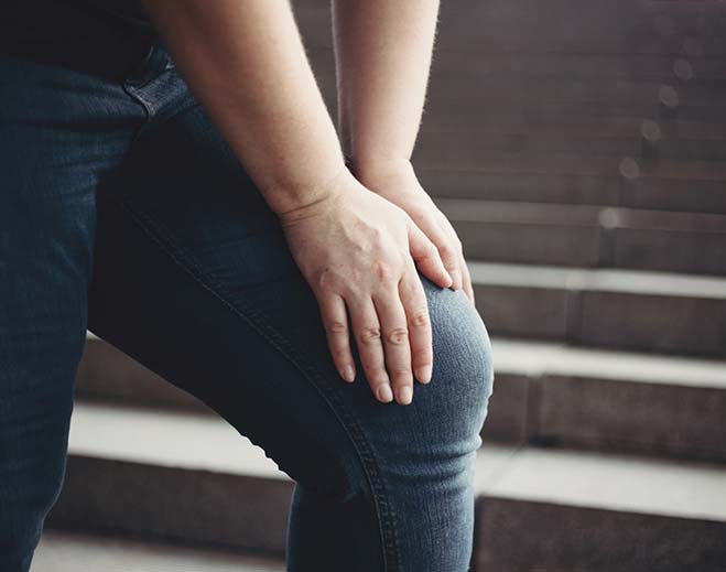 person holding knee