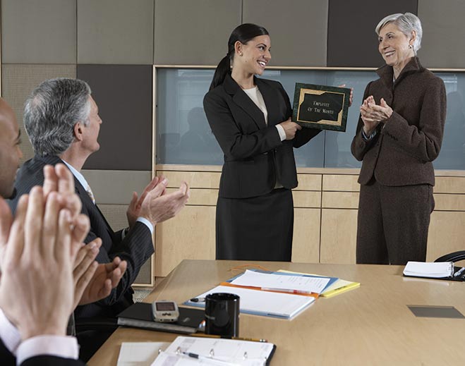 award-executives-applauding-woman-standing-up