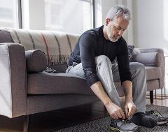 659x519-ca-man-tying-sneakers-cauc Man tying sneakers